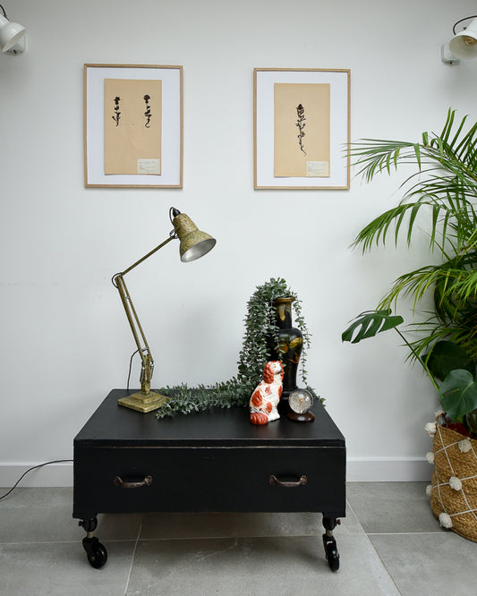 Ebonised black industrial coffee chest table on wheels with vintage handles