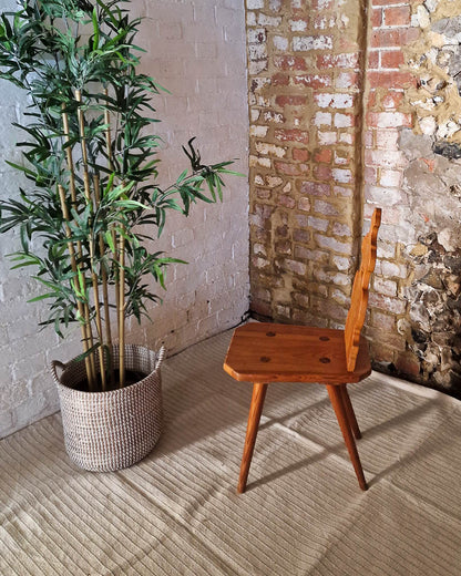 Vintage solid wood chair in Tyrolean brutalist style with carved decorative backrest, rustic farmhouse accent chair with warm wood tones