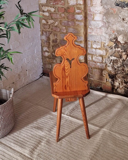 Vintage solid wood chair in Tyrolean brutalist style with carved decorative backrest, rustic farmhouse accent chair with warm wood tones