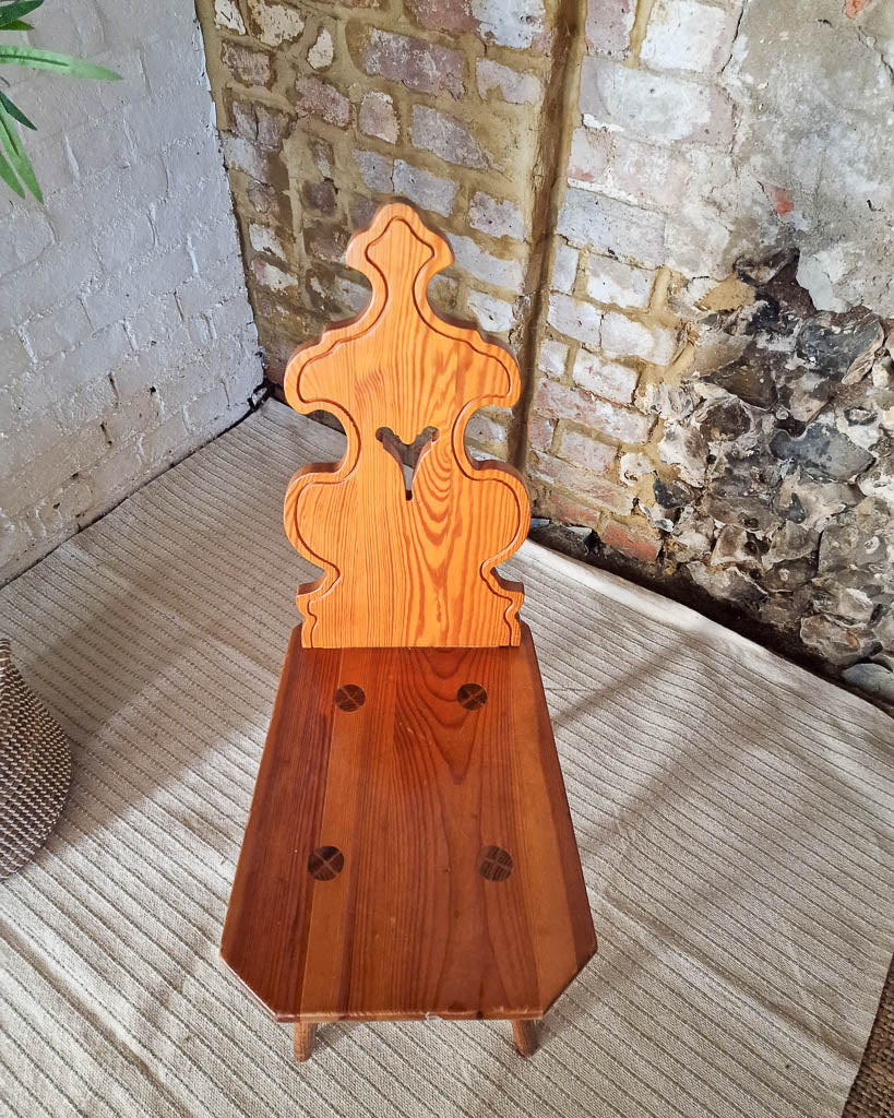 Vintage solid wood chair in Tyrolean brutalist style with carved decorative backrest, rustic farmhouse accent chair with warm wood tones