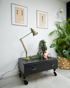 Ebonised black industrial coffee chest table on wheels with vintage handles
