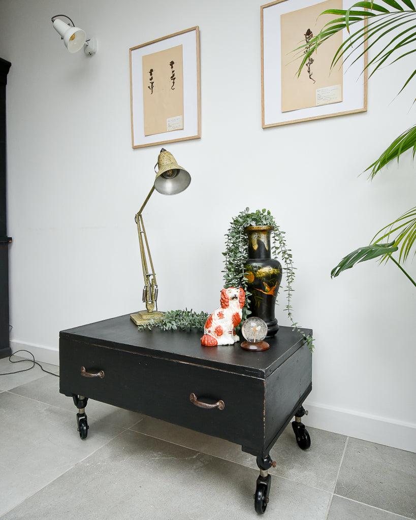 Ebonised black industrial coffee chest table on wheels with vintage handles