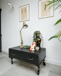 Ebonised black industrial coffee chest table on wheels with vintage handles