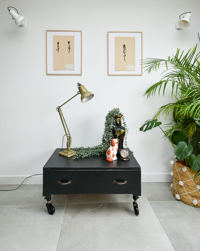 Ebonised black industrial coffee chest table on wheels with vintage handles