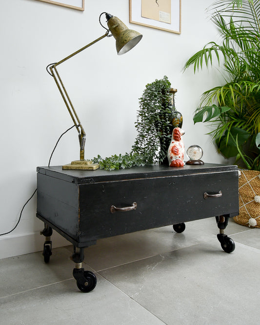 Ebonised black industrial coffee chest table on wheels with vintage handles