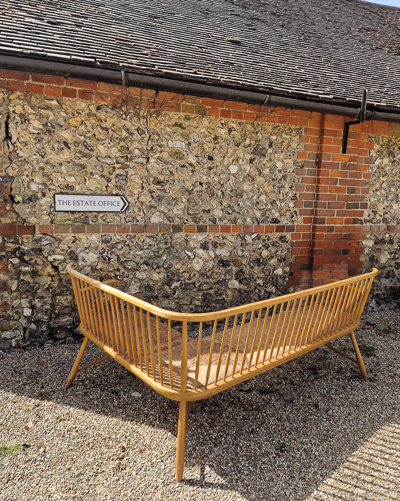 1950s Arno Lambrecht corner bench with rush seating in vintage workshop setting, mid century wooden L-shaped bench detail
